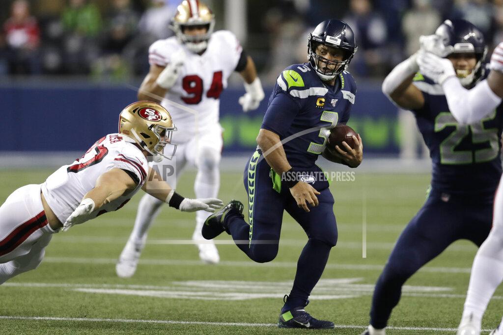 Stephen Brashear Seattle Seahawks quarterback Russell Wilson (3) is chased by San Francisco 49ers' Nick Bosa on a carry during the second half of an NFL football game, Sunday, Dec. 29, 2019, in Seattle. (AP Photo/Stephen Brashear)