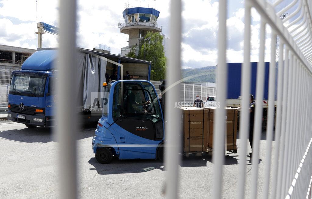 Uncredited Civil protection workers move boxes of ventilators at the customs post in the Bosnia capital Sarajevo, Thursday, April 30, 2020. In their initial report, the Bosnian state prosecutors said in a statement released Monday May 11, 2020, that the ventilators imported from China by private company Silver Raspberry, and paid for by the country’s government, have been found to be useless for COVID-19 coronavirus patients. (AP Photo)