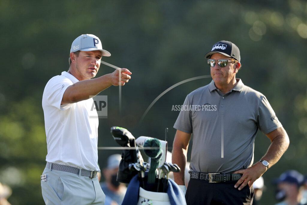 Curtis Compton Bryson DeChambeau, left, talks with Phil Mickelson on the 10th tee during a practice round for the Masters golf tournament in Augusta, Ga., Wednesday, April 7, 2021. (Curtis Compton/Atlanta Journal-Constitution via AP)