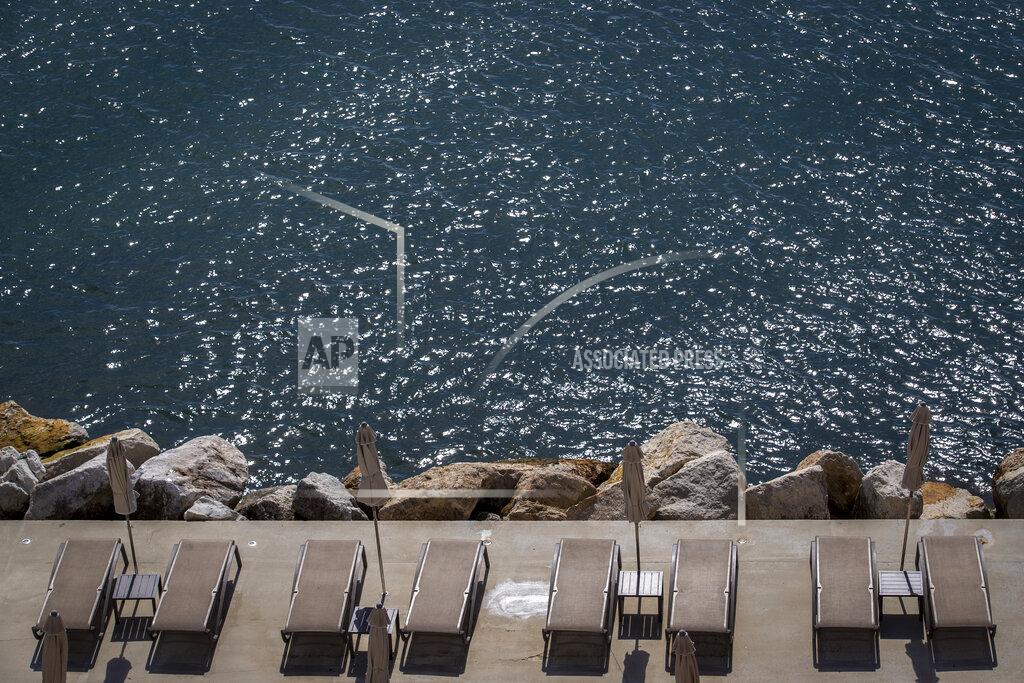 Beach loungers are set for tourists in Opatija, Croatia, Saturday, May 15, 2021. Croatia has opened its stunning Adriatic coastline for foreign tourists after a year of depressing coronavirus lockdowns and restrictions. (AP Photo/Darko Bandic)