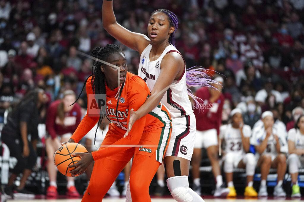 Sean Rayford Miami forward Maeva Djaldi-Tabdi (33) is defended by South Carolina forward Aliyah Boston, right, during the second half a second-round game in the NCAA college basketball tournament Sunday, March 20, 2022 in Columbia, S.C. South Carolina won 49-33. (AP Photo/Sean Rayford)