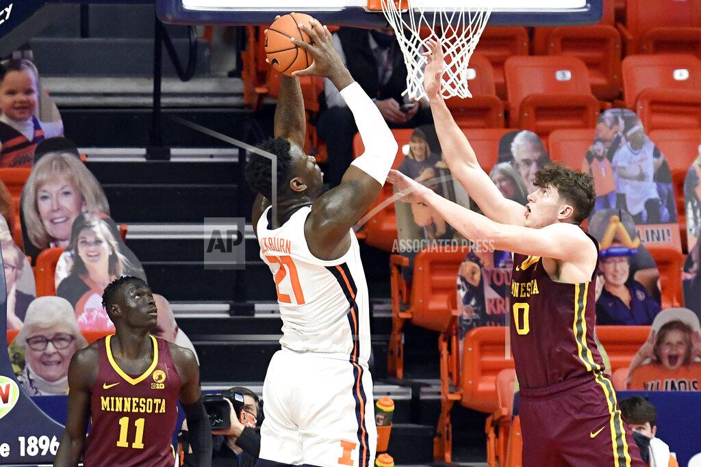 Holly Hart Illinois center Kofi Cockburn (21) goes in for the slam dunk as Minnesota's center Liam Robbins (0) defends in the second half of an NCAA college basketball game Tuesday, Dec. 15, 2020, in Champaign, Ill. (AP Photo/Holly Hart)