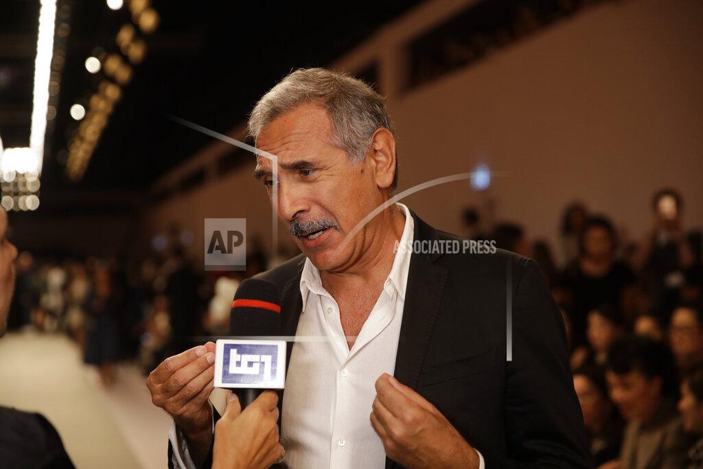 FILE - In this Thursday, Sept. 20, 2018 file photo, Carlo Capasa, head of the National Chamber of Italian Fashion, attends the Fendi women's 2019 Spring-Summer fashion show, during the Fashion Week in Milan, Italy. Italy’s fashion chamber opens the first Milan Fashion Week on Friday with no VIPS populating runway front rows, as the reality of the persistent virus resurgence in Italy has forced an all-digital, no physical week of menswear previews. (AP Photo/Luca Bruno, File)
