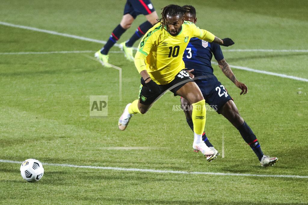 Ronald Zak Jamaica's Kasey Palmer, foreground, duels for the ball with USA's Kellyn Acosta during the international friendly soccer match between USA and Jamaica at SC Wiener Neustadt stadium in Wiener Neustadt, Austria, Thursday, March 25, 2021. (AP Photo/Ronald Zak)