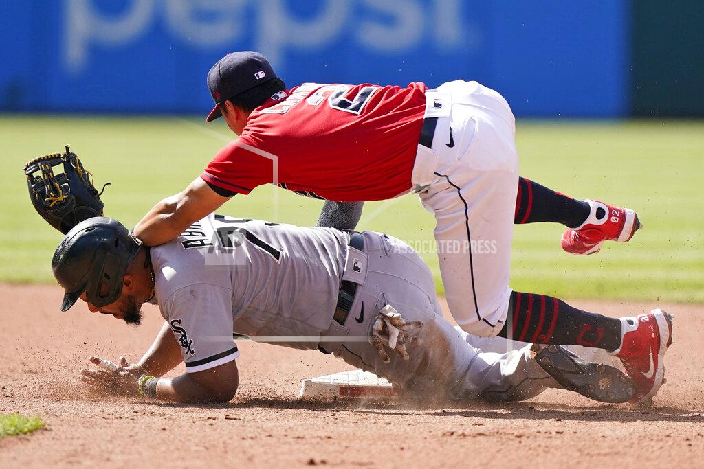 Tony Dejak Chicago White Sox's Jose Abreu, bottom, is safe at second base as Cleveland Indians' Yu Chang lets the ball get by in the sixth inning of the first baseball game of a doubleheader, Monday, May 31, 2021, in Cleveland. Indians' Cesar Hernandez was charged with a throwing error. (AP Photo/Tony Dejak)