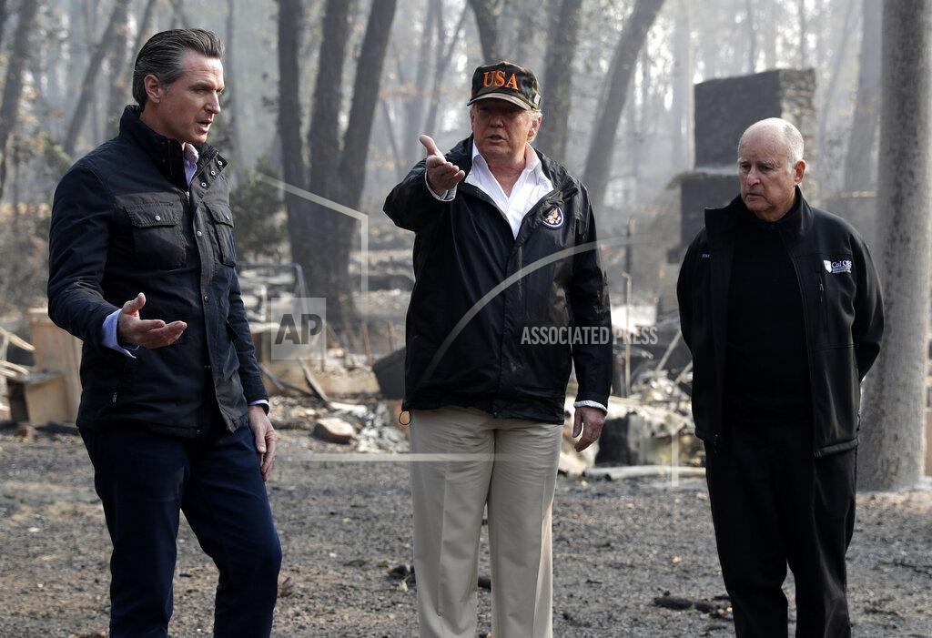 FILE - In this Nov. 17, 2018 file photo President Donald Trump talks with Gov.-elect Gavin Newsom, left, and as California Gov. Jerry Brown listens during a visit to a neighborhood impacted by the wildfires in Paradise, Calif. Newsom and Trump, who are often critical of each other, are getting along during the coronavirus pandemic. (AP Photo/Evan Vucci, File)