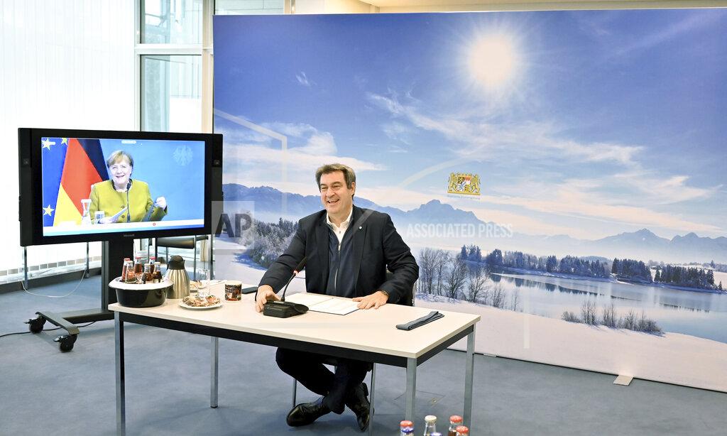 Peter Kneffel Markus Soeder, Prime Minister of Bavaria, center, takes part in a video conference with Chancellor Angela Merkel, left, and Bavarian district councils and mayors in the Bavarian State Chancellery in Munich, Germany, Friday, Feb. 19, 2021. (Peter Kneffel/Pool via AP)