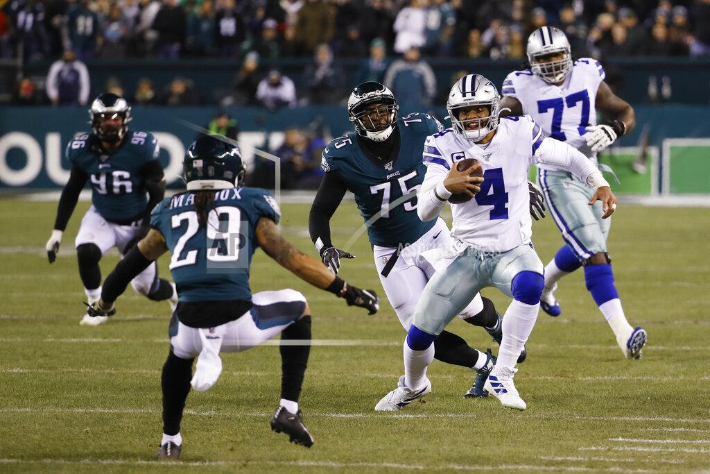 Chris Szagola Dallas Cowboys quarterback Dak Prescott (4) runs with the ball as Philadelphia Eagles' Avonte Maddox (29) and Vinny Curry (75) try to stop him during the first half of an NFL football game Sunday, Dec. 22, 2019, in Philadelphia. (AP Photo/Chris Szagola)
