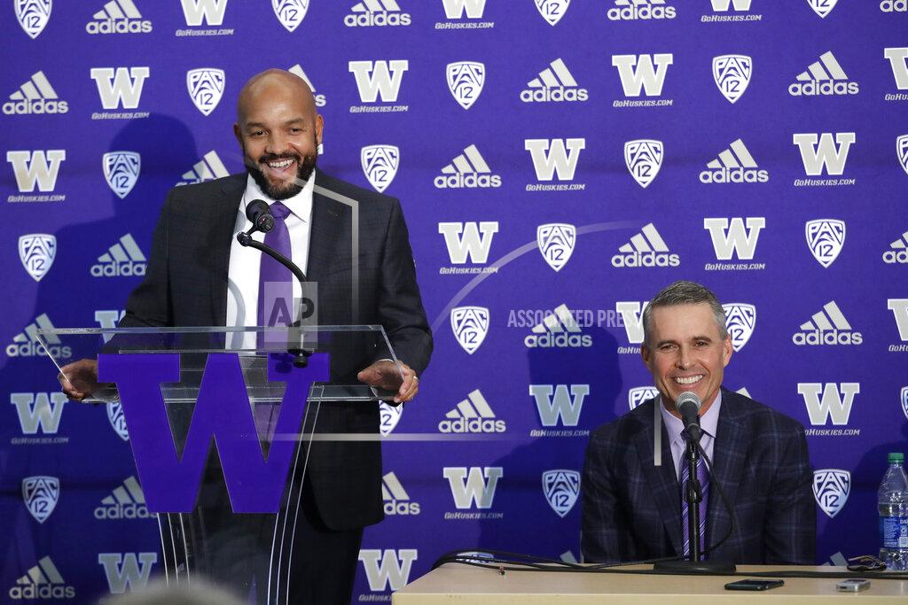 Elaine Thompson Washington NCAA college football defensive coordinator Jimmy Lake, left, speaks about taking over the head coaching position from Chris Petersen, right, during a news conference, Tuesday, Dec. 3, 2019, in Seattle. Petersen unexpectedly resigned on Monday, a shocking announcement with the Huskies coming off a 7-5 regular season and bound for a sixth straight bowl game under his leadership. Petersen will coach Washington in a bowl game, his final game in charge. (AP Photo/Elaine Thompson)