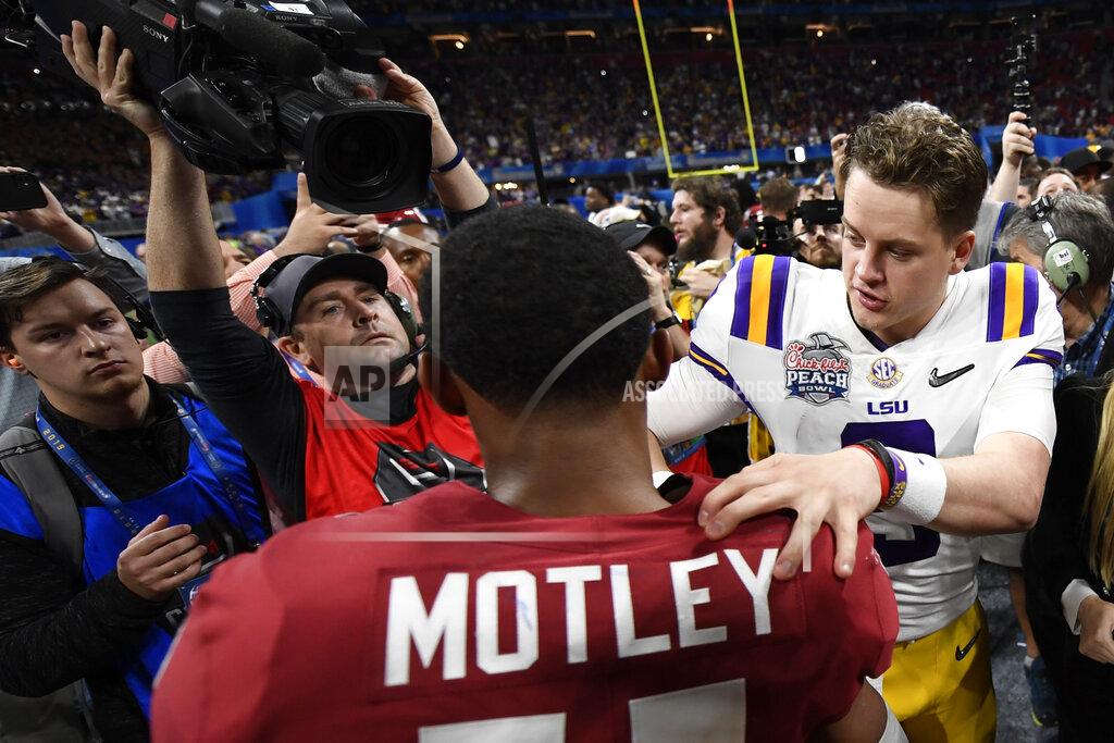 Danny Karnik LSU quarterback Joe Burrow (9) speaks with Oklahoma cornerback Parnell Motley (11) after the Peach Bowl NCAA semifinal college football playoff game, Saturday, Dec. 28, 2019, in Atlanta. LSU won 63-28. (AP Photo/Danny Karnik)