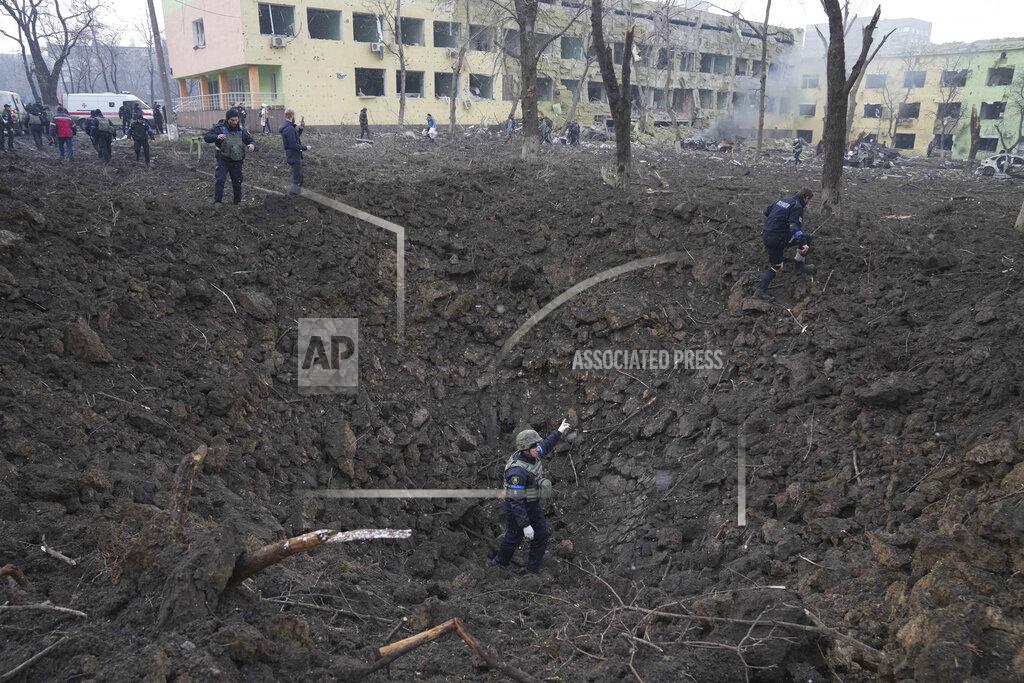 Evgeniy Maloletka FILE - Ukrainian soldiers and emergency employees work outside a damaged maternity hospital in Mariupol, Ukraine, Wednesday, March 9, 2022. A Russian attack has severely damaged the hospital in the besieged port city of Mariupol, Ukrainian officials say. (AP Photo/Evgeniy Maloletka, File)