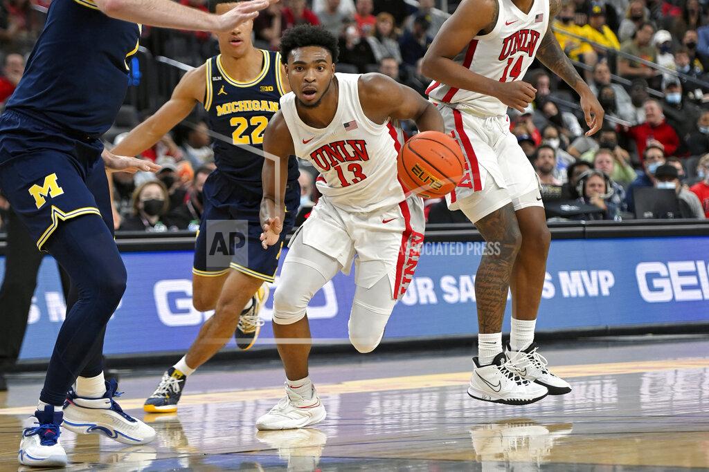 David Becker UNLV guard Bryce Hamilton (13) drives the ball against Michigan during the first half of an NCAA college basketball game Friday, Nov. 19, 2021, in Las Vegas. (AP Photo/David Becker)