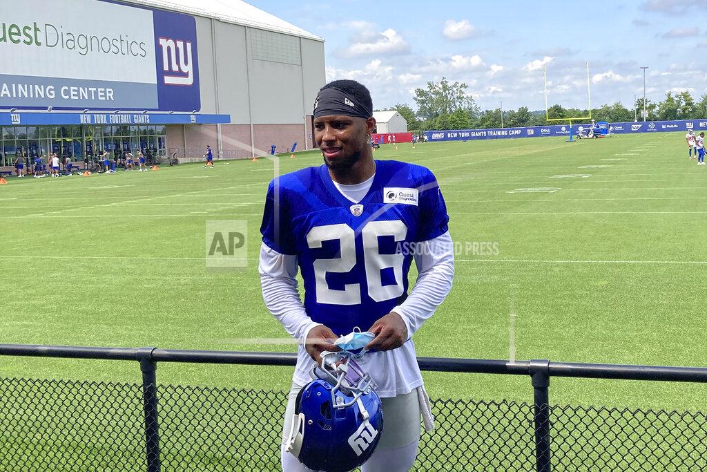 Tom Canavan New York Giants' Saquon Barkley waits to speak to reporters at the NFL football teams training facility in East Rutherford, N.J., Monday, Aug. 9, 2021. The New York Giants have activated Saquon Barkley from the physically unable to perform, although it's likely the star running back will not do much immediately. Coach Joe Judge made the announcement Monday, noting Barkley is not going to be pushed and there is no timetable to get him into a preseason game — or even play when the season opens on Sept. 12.(AP Photo/Tom Canavan)