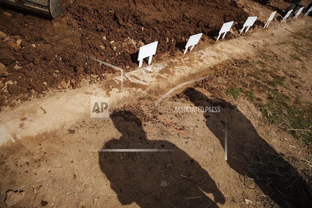 David Goldman Temporary placards mark the plots of those recently buried, mostly from coronavirus, at Hebrew Free Burial Association's Mount Richmond Cemetery in the Staten Island borough of New York, Tuesday, April 7, 2020. The association was used to burying one person on an average day. A "crazy day," executive director Amy Koplow says, would be five. The other day, they put 11 people in the ground. (AP Photo/David Goldman)
