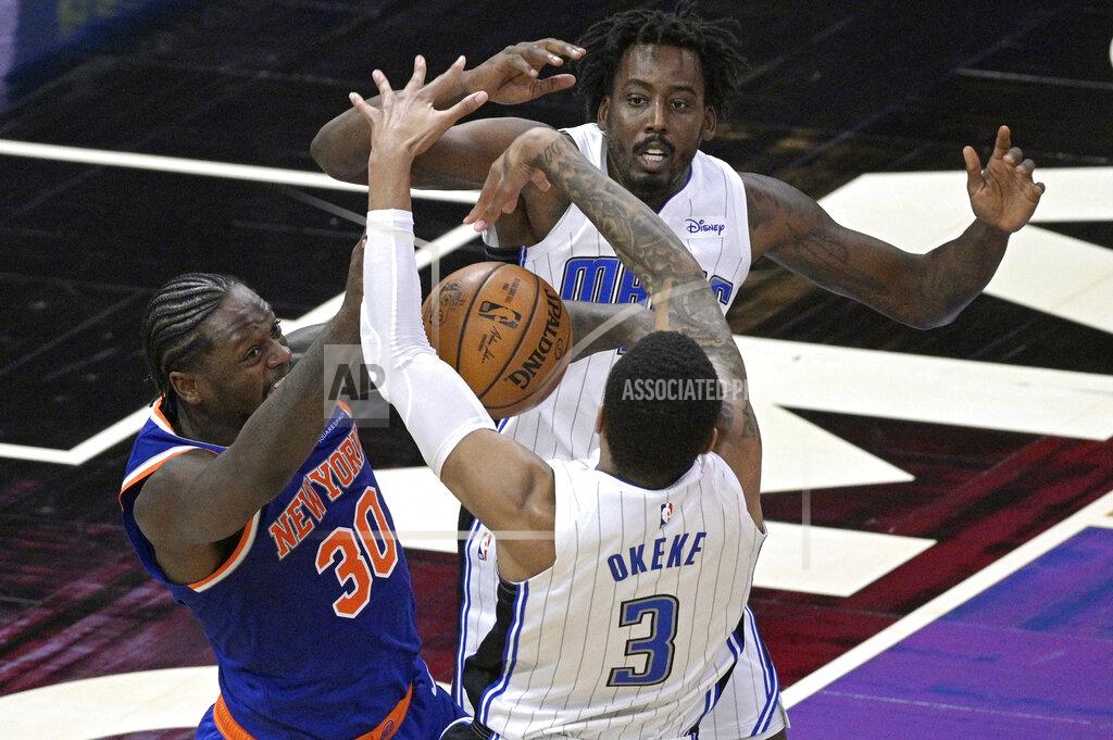 Phelan M. Ebenhack Orlando Magic forward Chuma Okeke (3) strips the ball from New York Knicks forward Julius Randle (30) as Magic forward Al-Farouq Aminu helps defend during the second half of an NBA basketball game Wednesday, Feb. 17, 2021, in Orlando, Fla. (AP Photo/Phelan M. Ebenhack)