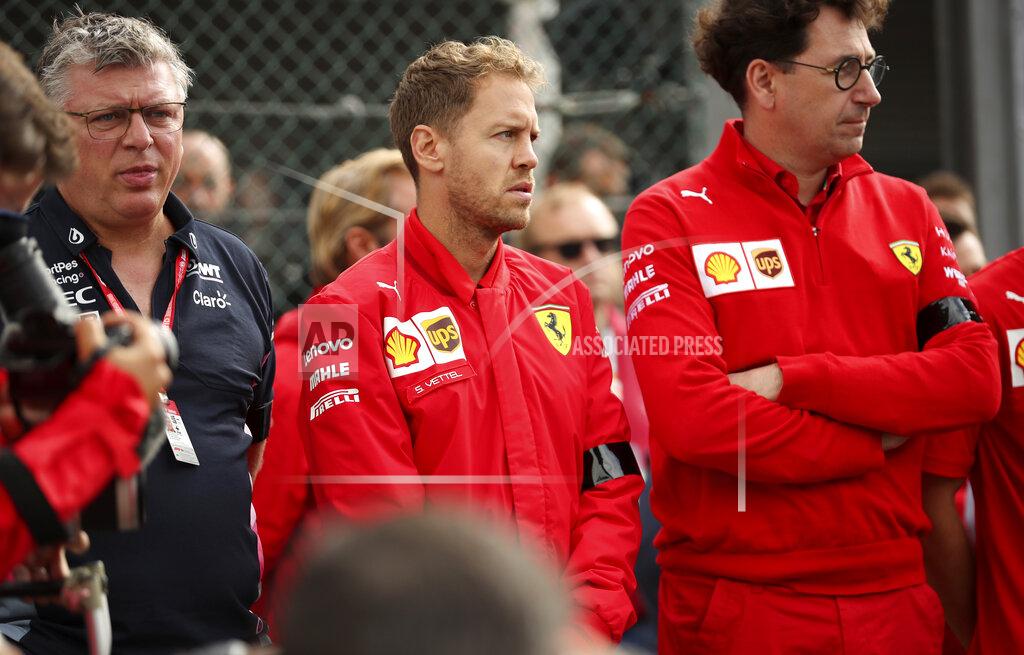 Francisco Seco Ferrari driver Sebastian Vettel of Germany, center, and Ferrari team principal Mattia Binotto, right, stand during a moment of silence for Formula 2 driver Anthoine Hubert at the Belgian Formula One Grand Prix circuit in Spa-Francorchamps, Belgium, Sunday, Sept. 1, 2019. The 22-year-old Hubert died following an estimated 160 mph (257 kph) collision on Lap 2 at the high-speed Spa-Francorchamps track, which earlier Saturday saw qualifying for Sunday's Formula One race. (AP Photo/Francisco Seco)