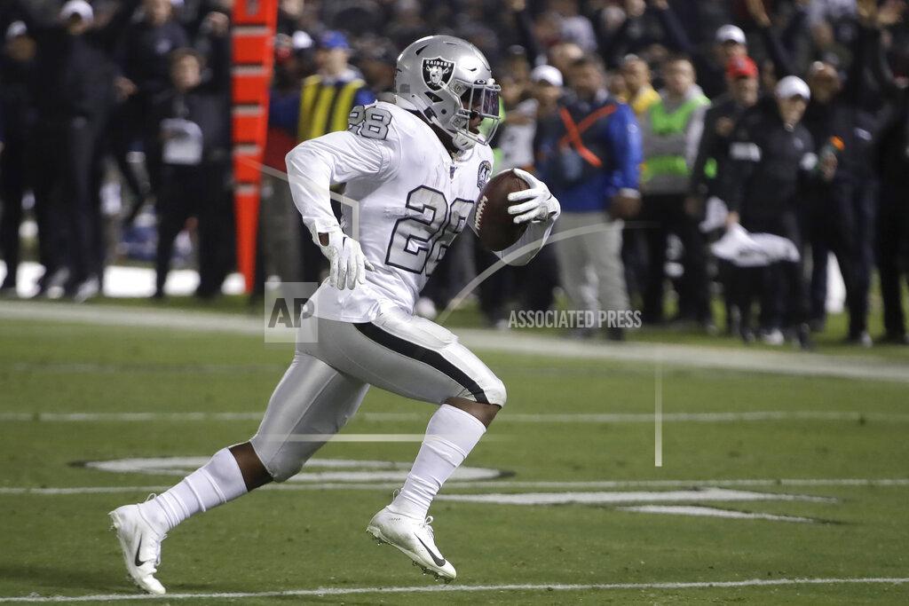 Oakland Raiders running back Josh Jacobs runs on the way to a touchdown against the Los Angeles Chargers during the second half of an NFL football game in Oakland, Calif., Thursday, Nov. 7, 2019. (AP Photo/Ben Margot)