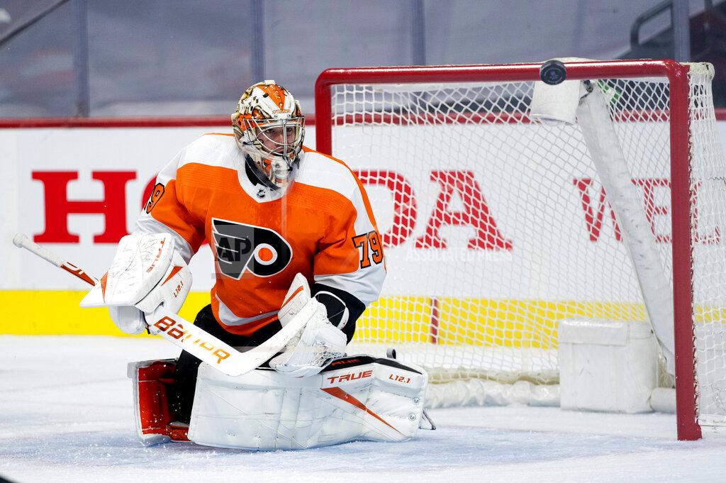 Chris Szagola Philadelphia Flyers' goaltender Carter Hart watches as the puck flies away from him during the first period of an NHL hockey game against the Pittsburgh Penguins, Wednesday, Jan. 13, 2021, in Philadelphia. (AP Photo/Chris Szagola)