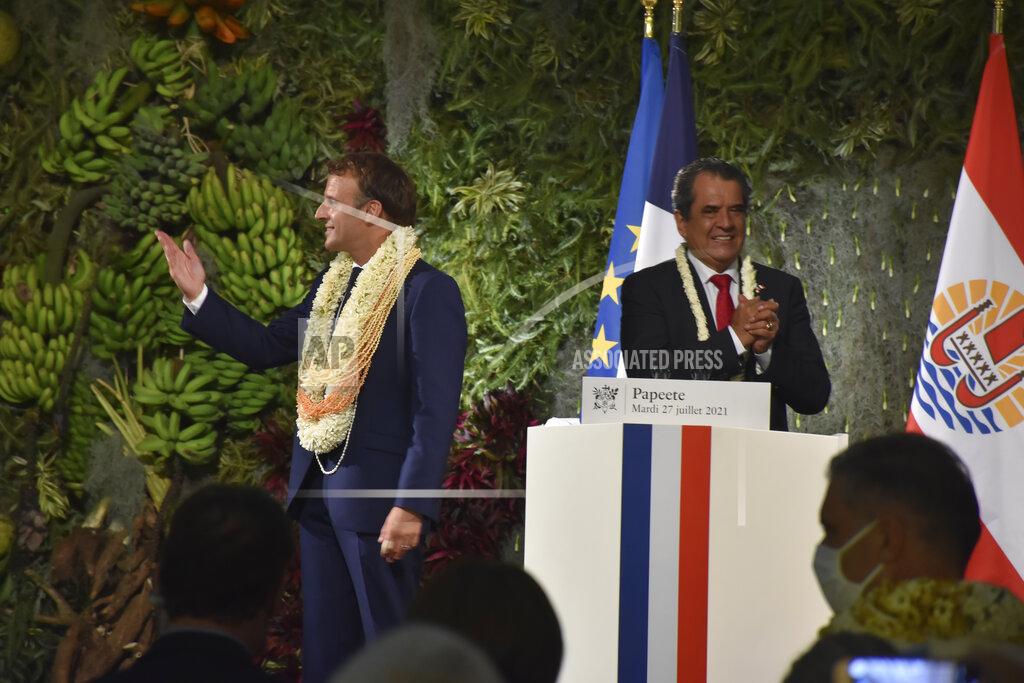 Esther Cuneo France's President Emmanuel Macron wearing a flower lei and seashell necklaces and French Polynesia Edouard Fritch acknowledge applauses after their speeches in Tahiti, French Polynesia in the Pacific Ocean, Tuesday, 27, 2021.President Emmanuel Macron reasserted France's presence in the Pacific on a visit to French Polynesia aimed in part at countering growing Chinese dominance in the region. (AP Photo/Esther Cuneo)