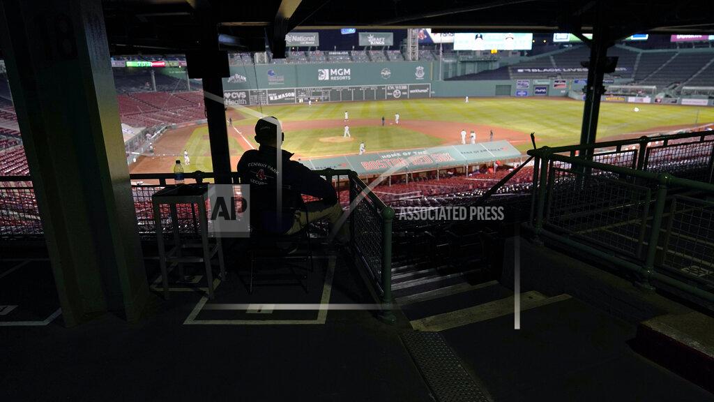 Charles Krupa A Boston Red Sox security guard watches from stands empty of fans during the fifth inning of a baseball game between the Red Sox and the Baltimore Orioles at Fenway Park in Boston, Thursday, Sept. 24, 2020. The Red Sox played their final home game of the COVID-19-disrupted season. (AP Photo/Charles Krupa)