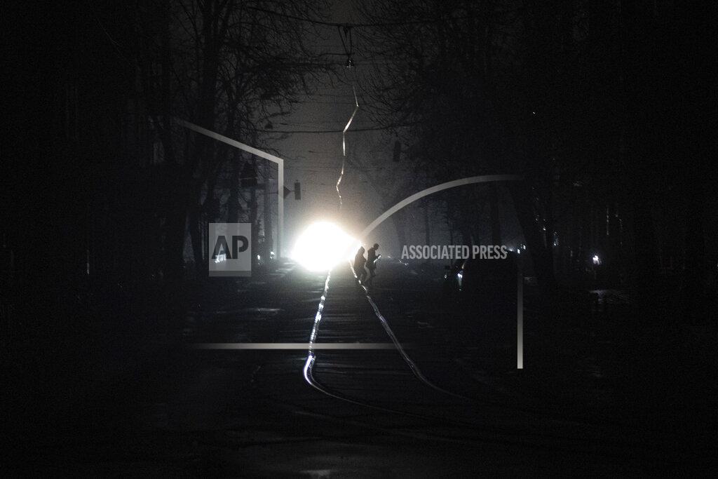 Evgeniy Maloletka People cross the road at the city center which lost electrical power after yesterday's Russian rocket attack in Kyiv, Ukraine, Thursday, Nov. 24, 2022. (AP Photo/Evgeniy Maloletka)