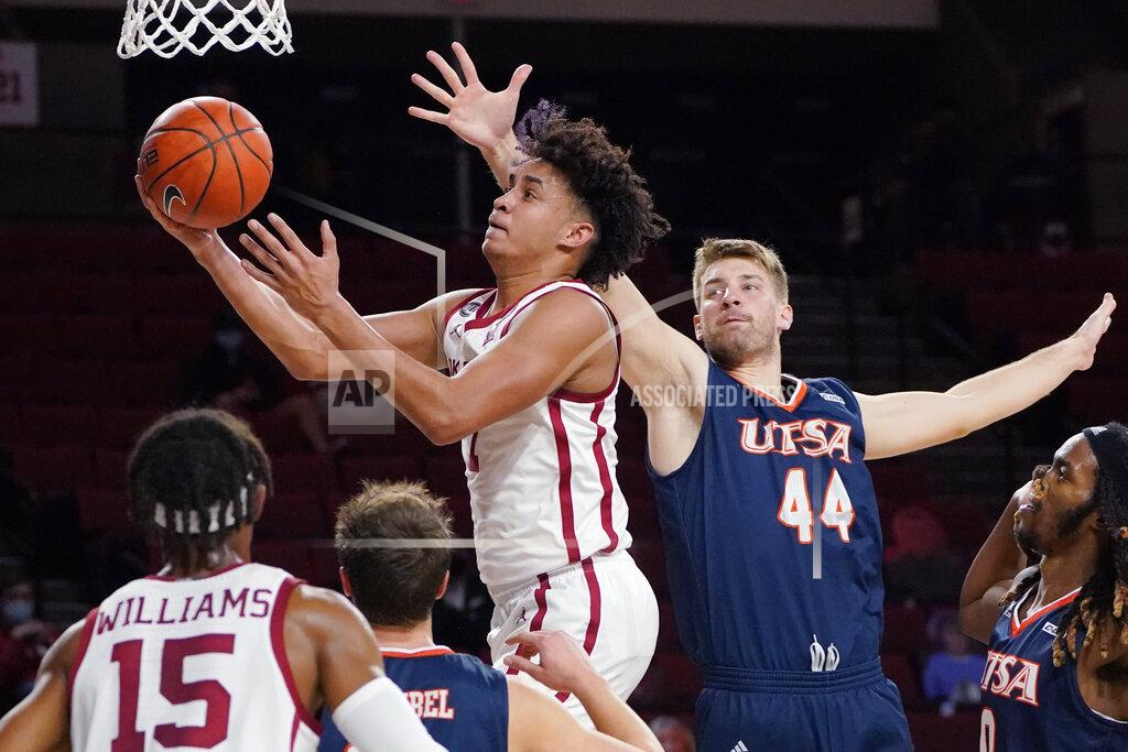 Sue Ogrocki Oklahoma forward Jalen Hill (1) goes to the basket in front of UTSA forward Luka Barisic (44) during the first half of an NCAA college basketball game Thursday, Dec. 3, 2020, in Norman, Okla. (AP Photo/Sue Ogrocki)