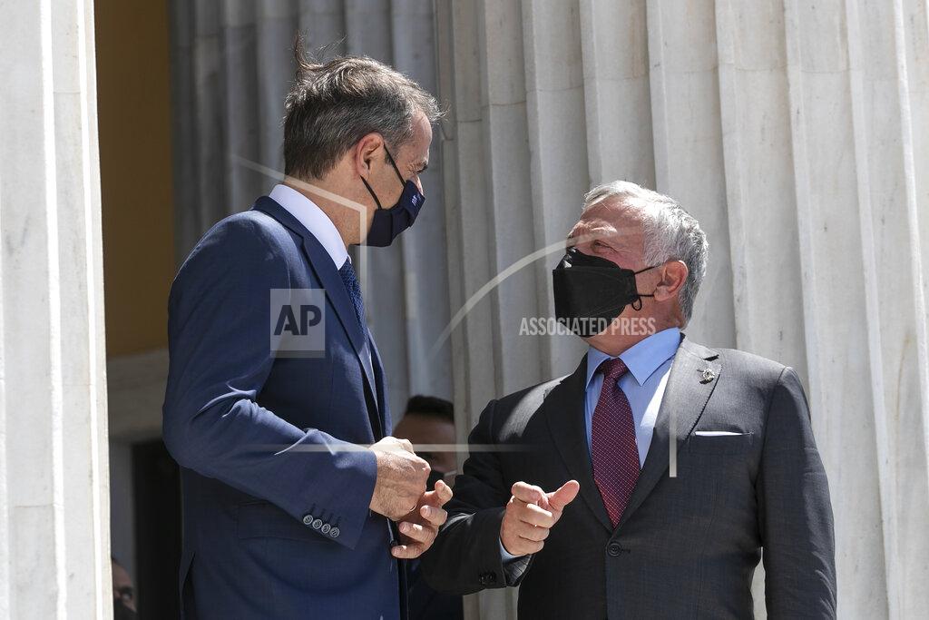 Yorgos Karahalis Jordan's King Abdullah II, right, speaks with Greek Prime Minister Kyriakos Mitsotakis ahead of a meeting in Athens, on Wednesday, July 28, 2021. Greece hosts a one-day trilateral meeting of Greece, Jordan and Cyprus. (AP Photo/Yorgos Karahalis)