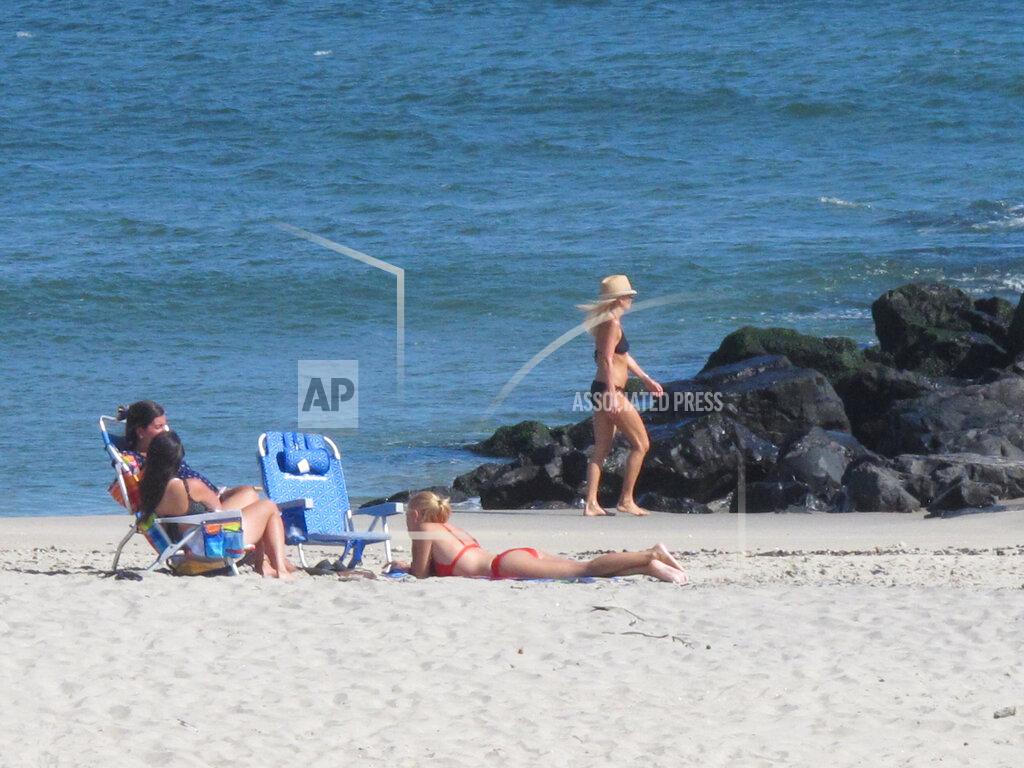Wayne Parry This Sept. 27, 2021, photo shows people on the beach in Deal, N.J. Deal is one of three Jersey Shore towns that will share a $26 million beach replenishment project starting in November. (AP Photo/Wayne Parry)