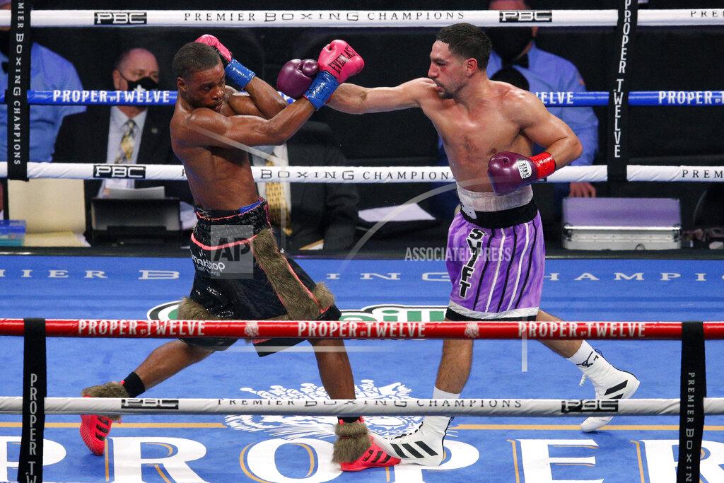 Brandon Wade Errol Spence Jr. steps back from a punch thrown by Danny Garcia during the WBC IBF welterweight championship boxing bout in Arlington, Texas, Saturday, Dec. 5, 2020. (AP Photo/Brandon Wade)