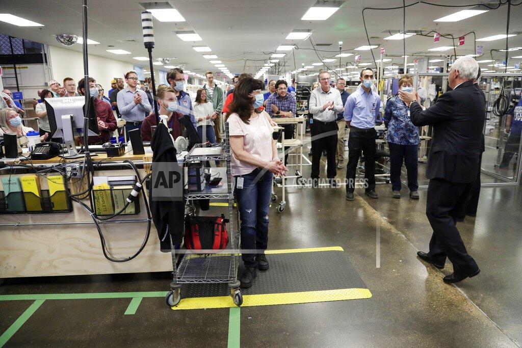 Morry Gash Vice President Mike Pence talks to workers at the GE Healthcare manufacturing facility Tuesday April 21, 2020, in Madison, Wis. (AP Photo/Morry Gash)