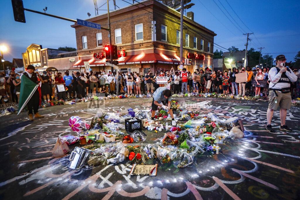 John Minchillo FILE - Protesters gather at a memorial for George Floyd, June 1, 2020, in front of Cup Foods in Minneapolis. Floyd was killed May 25 while in police custody outside the store. (AP Photo/John Minchillo, File)