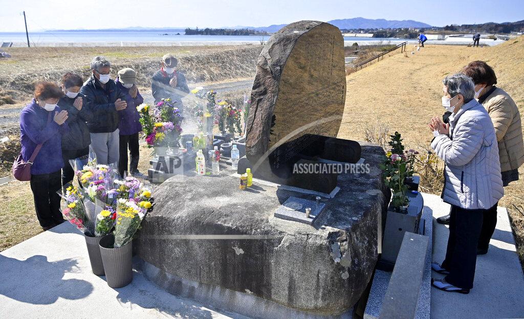 Yohei Nishimura People pray for victims of the 2011 massive earthquake and tsunami, at a memorial cenotaph in Kesennuma, Miyagi prefecture, Japan Thursday, March 11, 2021. Thursday marks the 10th anniversary of the massive earthquake, tsunami and nuclear disaster that struck Japan's northeastern coast. (Yohei Nishimura/Kyodo News via AP)