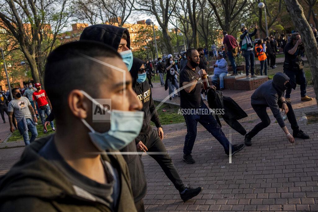 Bernat Armangue Left-wing protesters clash with police in Madrid's Vallecas neighborhood, Spain, Wednesday, April 7, 2021. Spanish police have used batons to keep protesters away from a campaign event of the far-right Vox party in Madrid. Scuffles started Wednesday when Santiago Abascal, the national leader of Vox, approached a crowd gathered to protest the party rally in Madrid's Vallecas neighborhood, a traditional left-wing bastion. Riot peace charged the bunches of protesters to keep them away from the party campaign event for upcoming regional elections. (AP Photo/Bernat Armangue)