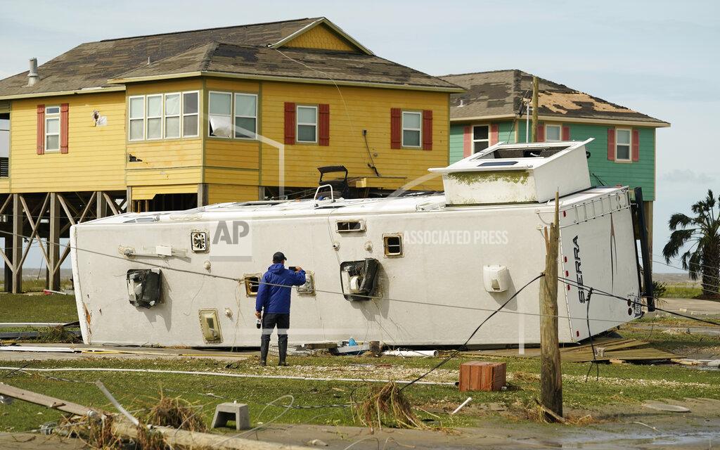 Eric Gay A journalist photographs damage left in the wake of Hurricane Laura, Thursday, Aug. 27, 2020, in Holly Beach, La. (AP Photo/Eric Gay)