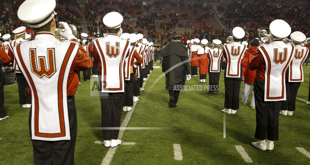 Andy Manis University of Wisconsin-Madison Marching Band Director Mike Leckrone walks between playing band members after an NCAA college football game Saturday, Nov. 24, 2018, in Madison, Wis. Leckrone is retiring after 50 years of directing the UW band. Minnesota beat Wisconsin 37-15. (AP Photo/Andy Manis)