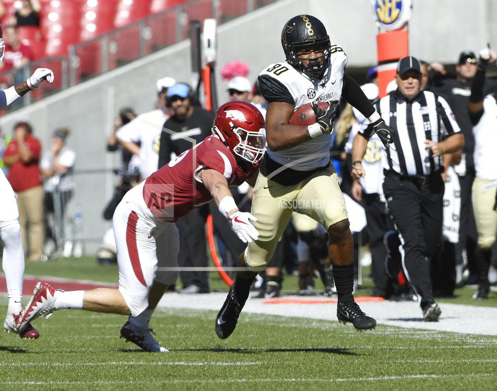 Michael Woods Arkansas defender Bumper Pool tackles Vanderbilt receiver Jared Pinkney in the second half of an NCAA college football game Saturday, Oct. 27, 2018, in Fayetteville, Ark. (AP Photo/Michael Woods)