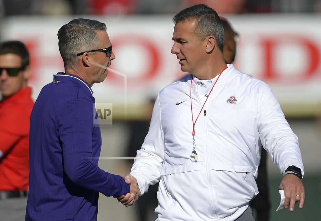 Mark J. Terrill Ohio State head coach Urban Meyer, right, and Washington head coach Chris Petersen shake hands before the Rose Bowl NCAA college football game Tuesday, Jan. 1, 2019, in Pasadena, Calif. (AP Photo/Mark J. Terrill)