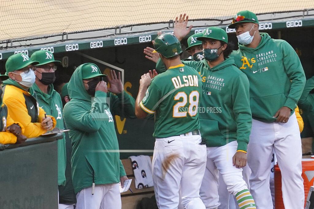 Jeff Chiu Oakland Athletics' Matt Olson (28) is congratulated by teammates after scoring a run against the Minnesota Twins during the fourth inning of the second baseball game of a doubleheader in Oakland, Calif., Tuesday, April 20, 2021. (AP Photo/Jeff Chiu)