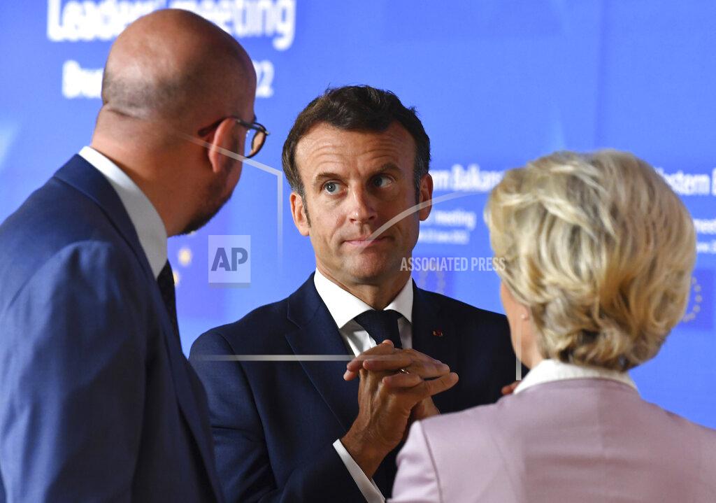 John Thys European Commission President Ursula von der Leyen, right, speaks with French President Emmanuel Macron, center, and European Council President Charles Michel prior to a group photo with Western Balkan leaders at an EU summit in Brussels, Thursday, June 23, 2022. European Union leaders are expected to approve Thursday a proposal to grant Ukraine a EU candidate status, a first step on the long toward membership. The stalled enlargement process to include Western Balkans countries in the bloc is also on their agenda at the summit in Brussels. (John Thys, Pool Photo via AP)