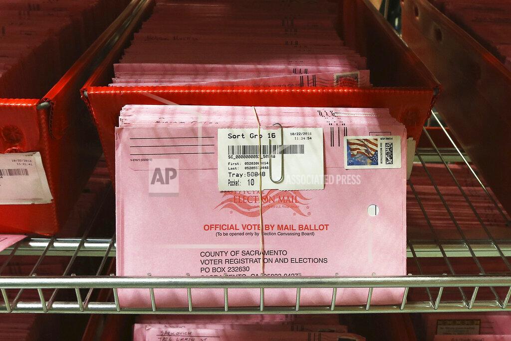 Rich Pedroncelli FILE - In this Oct. 22, 2018, file photo, mail-in ballots are placed in bins to be processed after arriving at the Sacramento County Registrar of Voters in Sacramento, Calif. Over 100,000 mail-in ballots were rejected by election officials in California's March 2020 presidential primary, highlighting a glaring gap in the effort to ensure every vote is counted as a national dispute rages over the integrity of vote-by-mail elections. (AP Photo/Rich Pedroncelli, File)
