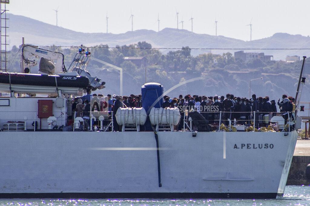 Fabio Peonia Migrants arrive in Porto Empedocle, Sicily, aboard two military ships after being transferred from the island of Lampedusa, where a number of small boat carrying migrants arrived in the last days, Monday, July 27, 2020. (Fabio Peonia/LaPresse via AP)
