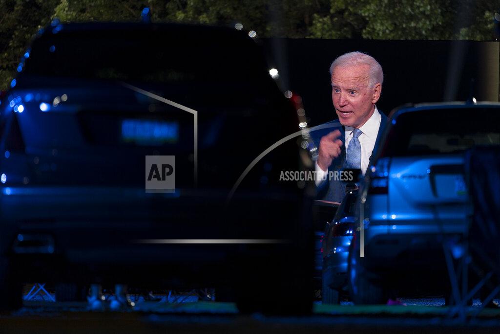 Carolyn Kaster Audience members watch from their cars as Democratic presidential candidate former Vice President Joe Biden, seen on a monitor, speaks during a CNN town hall in Moosic, Pa., Thursday, Sept. 17, 2020. (AP Photo/Carolyn Kaster)