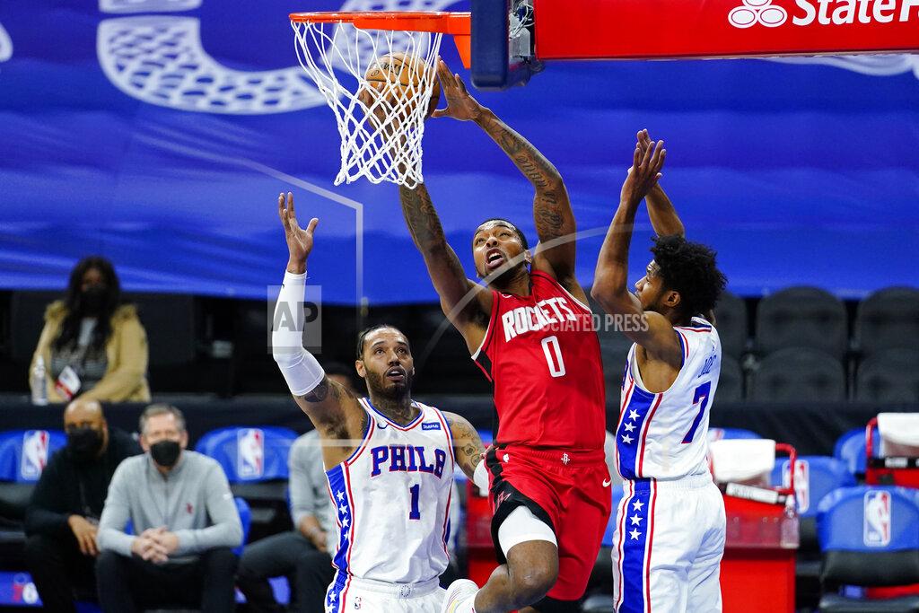 Matt Slocum Houston Rockets' Sterling Brown (0) goes up for a shot between Philadelphia 76ers' Mike Scott (1) and Isaiah Joe (7) during the first half of an NBA basketball game, Wednesday, Feb. 17, 2021, in Philadelphia. (AP Photo/Matt Slocum)