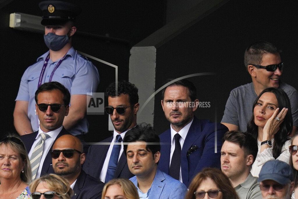 Kirsty Wigglesworth Former soccer player Frank Lampard, top second right, his wife Christine Lampard, right, Formula One driver Daniel Ricciardo, second left, watch the men's singles semifinals match on day eleven of the Wimbledon Tennis Championships in London, Friday, July 9, 2021. (AP Photo/Kirsty Wigglesworth)