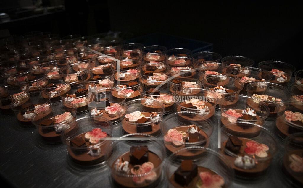 Virginia Mayo A dessert of chocolate, Amarena cherry, almond, ricotta and lime is ready to be packed into nearly 600 take-away orders at Sergio Herman's Le Pristine restaurant in Antwerp, Belgium, Saturday, Nov. 7, 2020. Of all the many challenges the pandemic throws up for all kinds of professions, this one has been particularly tough: How to put a three-star chef into a takeout box. (AP Photo/Virginia Mayo)