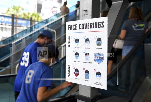 Gaston De Cardenas A health and safety sign is displayed on the ground level of loanDepot park prior to the opening day baseball game between the Tampa Bay Rays and the Miami Marlins, Thursday, April 1, 2021, in Miami. (AP Photo/Gaston De Cardenas)