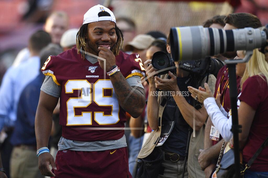 Susan Walsh Washington Redskins running back Derrius Guice (29) jokes around with photographers before an NFL preseason football game against the Baltimore Ravens in Landover, Md., Thursday, Aug. 29, 2019. (AP Photo/Susan Walsh)