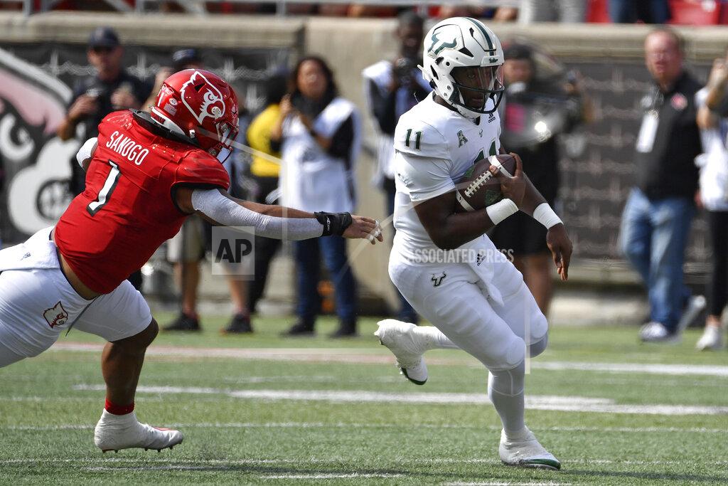 Timothy D. Easley South Florida quarterback Gerry Bohanon (11) runs from the grasp of Louisville linebacker Momo Sanogo (1) during the first half of an NCAA college football game in Louisville, Ky., Saturday, Sept. 24, 2022. (AP Photo/Timothy D. Easley)