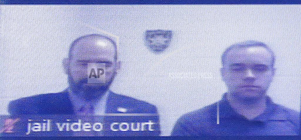 Former Atlanta police Officer Garrett Rolfe, right, appears on a television screen with attorney Lance LoRusso, Tuesday, June 30, 2020, in Atlanta. Rolfe, who fatally shot Rayshard Brooks when Brooks fired a Taser in his direction while running away after a struggle on June 12, can be free on bond while his case is pending. A judge set a bond of $500,000 for Rolfe, who faces charges, including felony murder. (AP Photo/Brynn Anderson, Pool)