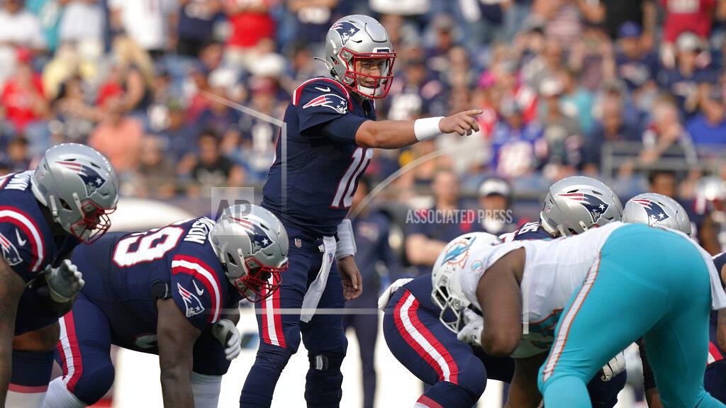 Steven Senne New England Patriots rookie quarterback Mac Jones (10) points on the line of scrimmage during the first half of an NFL football game against the Miami Dolphins, Sunday, Sept. 12, 2021, in Foxborough, Mass. (AP Photo/Steven Senne)